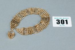 A nine carat gold six bar gate bracelet with padlock, 11 grms