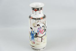 A Famille Rose Oriental vase, painted in enamels of figures at a table set before a blossom tree,