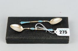 A cased pair of Norwegian silver gilt spoons with small bowls and decorative blue enamel filigree