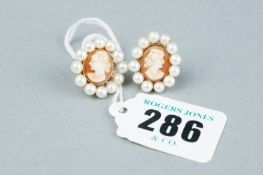 A pair of nine carat gold cameo stud earrings each with a twelve pearl surround