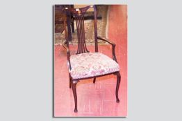 An Edwardian mahogany and inlaid open upholstered armchair on Queen Anne front supports