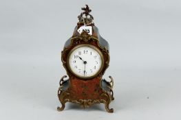 A small French Louis XV style boulle mantel clock, late 19th Century in an ebonized case, 12 ins (