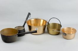 Two swing handled Victorian brass jam pans, two brass and iron handled saucepans and one other