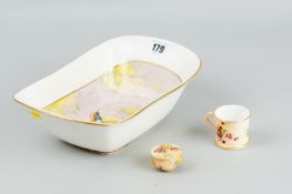 A Royal Worcester hand painted bowl showing a bird of paradise amongst hanging blossom, signed by