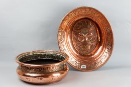 A 19th Century deep copper dish with reeded edge and leaf embossed border having an embossed