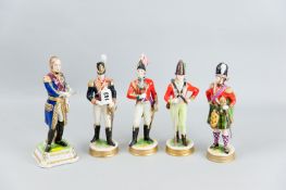 A group of five porcelain figures of men in military uniform, one on a square stepped base titled '