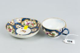 A first period cabinet cup and saucer with blue mottled background and gilt edged cartouche panels