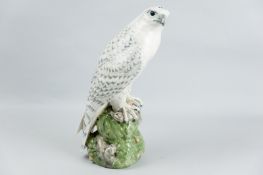 An excellent Royal Copenhagen figure of a Falcon perched proudly with slightly tilting head, its