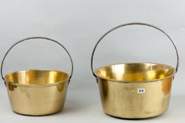 A large Victorian brass jam pan with polished iron handle and another similar, 14.75 ins (37.5