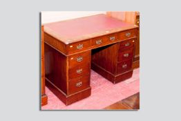 An Edwardian mahogany twin pedestal desk, red skiver inset top with rounded bull nose edging above a