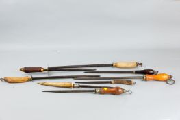 A collection of Georgian and later wooden and horn handled knife sharpeners with various metal