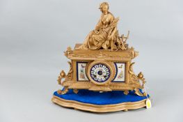 A French gilt metal and porcelain panelled mantel clock with associated stand, a Sevres style
