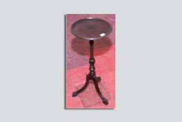 A Regency mahogany wine table having a circular dished top on a turned and reeded bulb column and