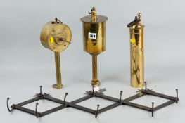 Two clockwork brass spit roasts, a brass cylindrical nutmeg grater with handle and a concertina iron