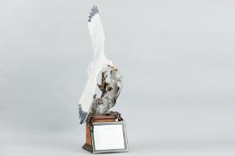 An Albany Fine China bronze and porcelain model of a Kittiwake in full flight over a bronze