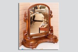 A good Victorian mahogany swing toilet mirror, a central shaped top mirror with flanking carved