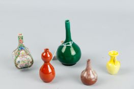 A group of five miniature vases, various shapes and colours including a four sided bottle vase