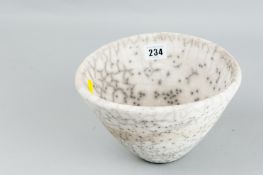A David Binns unglazed white clay bowl having a dark crackle and dot pattern throughout, unmarked,