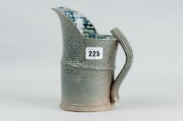 A Walter Keeler articulated salt glazed jug, overall mottled body in a grey blue glaze, 7.5 ins (
