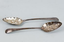 A pair of Georgian silver berry spoons with floral decorated handles, 3.5 ozs, London 1801 and 1802