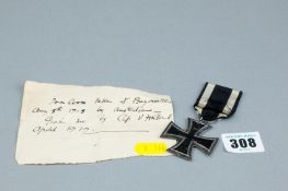 An Iron Cross second class with ribbon and accompanying slip of paper - 'Iron Cross Taken at