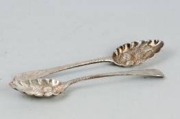 A pair of Georgian silver berry spoons with scrolled and chased handles, 4.7 ozs, London 1802