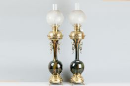 An excellent pair of early 20th Century brass and pottery electric lamps with raised brass decorated