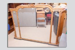 A Regency gilt triple overmantel mirror, the shaped top decorated with moulded acanthus leaf, the