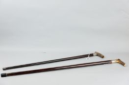 Two bone handled walking sticks, one 34 ins with floral and scrolled silver band, London 1919 and