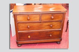 A Victorian mahogany chest of drawers, two short and two long drawers, cock beaded edges with turned