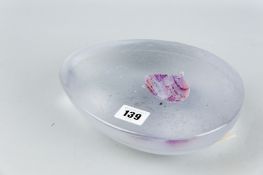 A kiln made glass sculpture by Bill Swann having a frosted mottled exterior and a polished top