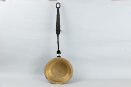 An early iron work and brass inglenook pan, 28 ins (71 cms) overall length (impact damage to edge)