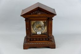An Edwardian oak cased mantel clock, a classical style case in the architectural style with