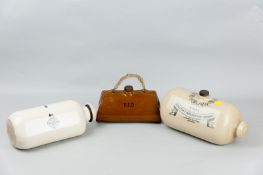Three decorative stoneware bedwarmers including one coloured and shaped like a Gladstone bag, made