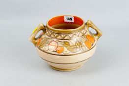 A Crown Ducal twin handled vase with tube line decoration by Charlotte Rhead of fruit and leaves