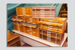 Eight multi-sectional six drawer chests containing a large quantity of lead type in various