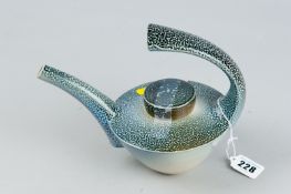 A Jeremy Nickols salt glazed lidded teapot with feature handle in a mottled blue grey glaze,