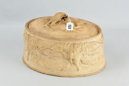 A late 19th Century terracotta game pie dish of oval form having birds and other game laid amongst