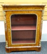 A mid-Victorian figured walnut pier-cabinet, the top with rounded corners, tulipwood cross-banding