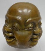 A bronze four faced Buddha bust with Chinese character marks to the base, 5 ins high (12.5 cms)