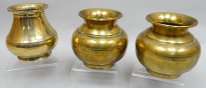 A pair of polished bronze vases with etched decoration, 4.75 ins high (11 cms) and another