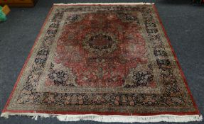 A rust and cobalt blue intricately patterned Persian wool carpet, 100 x 118 ins (253 x 299 cms)