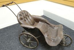 A Victorian coach-built three-wheel bath-chair on iron-springs, with buttoned brown leather seat,