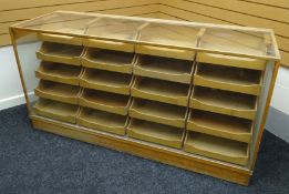 A late twentieth century light wood and glass retailer's counter display on a plinth base,