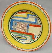 A Clarice Cliff 'Tennis' display plate in bright yellow glaze and colourful abstract interior, 9 ins