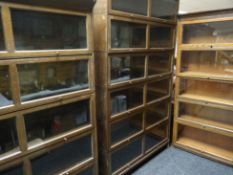 Three stackable matching vintage bookcases comprising a pair of tall and wide versions with six