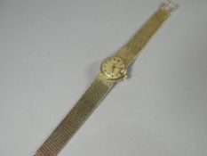 A ladies OMEGA 9ct automatic mesh-bracelet writwatch with date aperture, 38.36 gms total