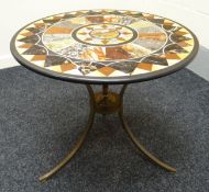 A circular specimen centre-table. The marble inlaid in a radiating geometric design upon a tripod