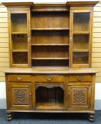 A neat turn-of-the-century carved oak dresser. The raised base with three drawers above a dog-kennel
