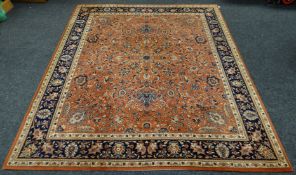 A pure wool floral patterned ochre and blue carpet, 118 x 98.5 ins (300 x 250 cms)